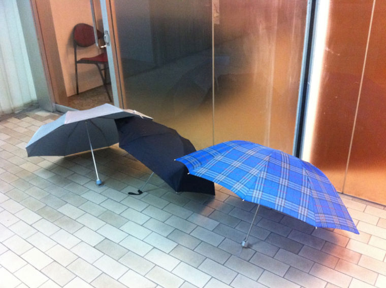 雨季のシンガポール　オフィス前は傘の列